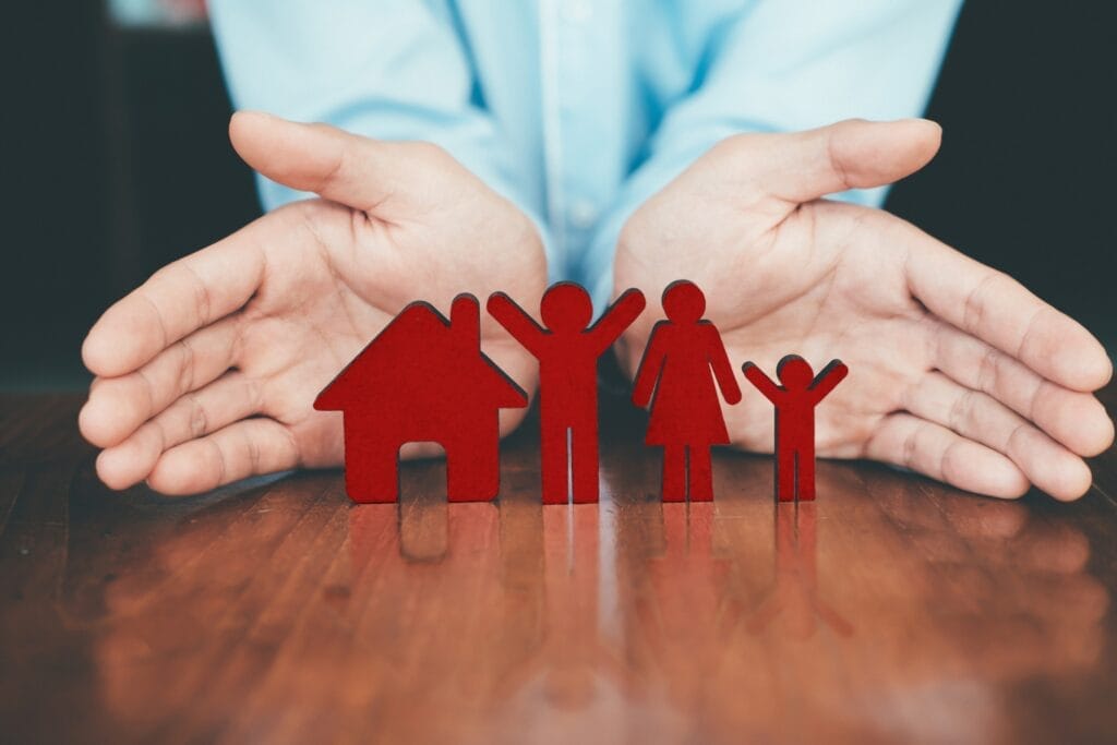 A man holding a family in his hands, discussing the Affordable Care Act Timeline.