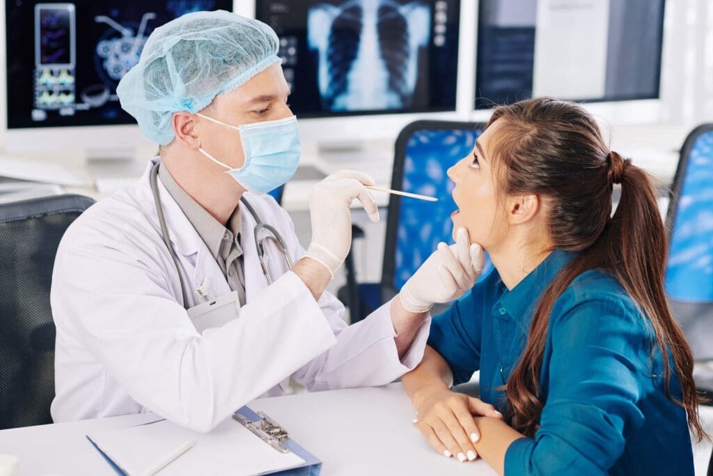 A woman is undergoing a medical examination by a doctor for life insurance purposes.