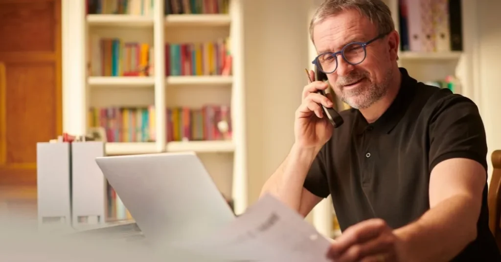 Small business owner reviewing group health insurance options with a local broker in Houston, Texas.