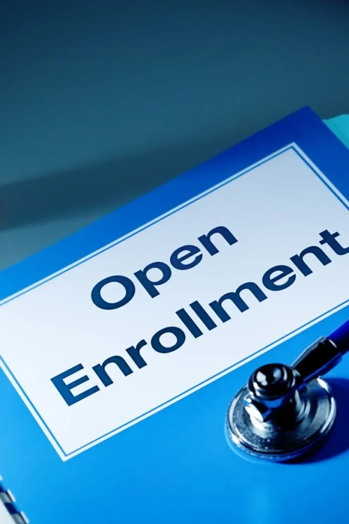 Open enrollment document with stethoscope.